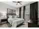 Comfortable bedroom with a bed, two windows, and black-out curtains at 8990 Cuban Palm Rd, Kissimmee, FL 34747