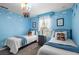 Bright ' bedroom with themed decor, two twin beds, cloud accents, and a large window at 8990 Cuban Palm Rd, Kissimmee, FL 34747