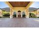 Impressive facade of the community clubhouse featuring large windows, pillars, and well-kept landscaping at 8990 Cuban Palm Rd, Kissimmee, FL 34747