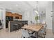 View of dining area with seating, cabinetry, breakfast bar and modern lighting at 8990 Cuban Palm Rd, Kissimmee, FL 34747