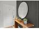 Stylish entryway featuring a wooden console table with decor and an oval mirror at 8990 Cuban Palm Rd, Kissimmee, FL 34747