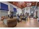 Inviting lobby featuring a seating area, front desk, and bright, open space with tile flooring and a wood-plank ceiling at 8990 Cuban Palm Rd, Kissimmee, FL 34747