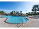 Relaxing swimming pool with a rock waterfall feature and palm trees, creating a tropical oasis for residents at 8990 Cuban Palm Rd, Kissimmee, FL 34747