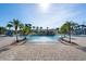 Resort-style pool area with palm trees, a central waterfall feature, and ample deck space for lounging at 8990 Cuban Palm Rd, Kissimmee, FL 34747