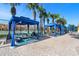 Resort-style poolside cabanas offering shaded seating and relaxation near the community pool and tennis courts at 8990 Cuban Palm Rd, Kissimmee, FL 34747