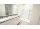 Bathroom showcasing granite countertops, dual sinks, and a shower stall at 1003 Cascade Dr, Davenport, FL 33837