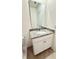 Bathroom features vanity with granite counters, white cabinets and large mirror at 1003 Cascade Dr, Davenport, FL 33837