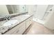 Bathroom featuring granite countertops, dual sinks, and a modern shower at 1003 Cascade Dr, Davenport, FL 33837