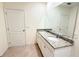 Bathroom featuring double vanity with granite countertop, large mirror, and tile flooring at 1003 Cascade Dr, Davenport, FL 33837