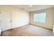 The carpeted bedroom provides a closet and a window for natural light at 1003 Cascade Dr, Davenport, FL 33837