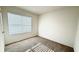 Bright bedroom with neutral carpet, white walls, and a large window with blinds at 1003 Cascade Dr, Davenport, FL 33837