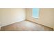 A bright, carpeted bedroom has a window that provides natural light at 1003 Cascade Dr, Davenport, FL 33837