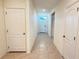Open hallway with tile floor, white doors and trim and natural light at 1003 Cascade Dr, Davenport, FL 33837