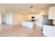 Open floorplan kitchen with island, stainless appliances, white cabinets and tile floors at 1003 Cascade Dr, Davenport, FL 33837