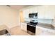 Kitchen boasts stainless steel appliances, granite countertops, and white cabinets at 1003 Cascade Dr, Davenport, FL 33837