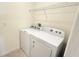 The laundry room features a washer, dryer, and shelving at 1003 Cascade Dr, Davenport, FL 33837