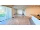 Open-concept living room features tile flooring, sliding glass doors to the patio, and lots of natural light at 1003 Cascade Dr, Davenport, FL 33837