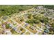 An aerial view reveals a well-planned community surrounded by lush greenery and mature trees at 102 Sail Way, Kissimmee, FL 34759