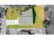 Aerial view of home showcasing the roof, driveway, and surrounding green lawn and trees at 102 Sail Way, Kissimmee, FL 34759