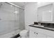Modern bathroom with a glass-enclosed shower, sleek vanity with black countertop, and modern fixtures at 102 Sail Way, Kissimmee, FL 34759