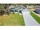 Beautiful single-story home featuring a well-manicured lawn and a spacious two-car garage at 102 Sail Way, Kissimmee, FL 34759