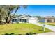 Charming single-story home with well-kept lawn and a two-car garage; great curb appeal at 102 Sail Way, Kissimmee, FL 34759