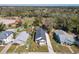 The aerial view displays the house with a detached garage on the property surrounded by grass and other homes at 1112 W Line St, Leesburg, FL 34748