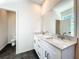 Stylish bathroom featuring a double sink vanity with white marble countertops and sleek gray flooring at 1112 W Line St, Leesburg, FL 34748
