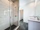 Modern bathroom with a glass shower enclosure, dual sinks, and elegant black and white tiling at 1112 W Line St, Leesburg, FL 34748