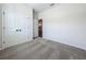 Bedroom featuring neutral carpet, closet with double doors, and an open doorway at 1112 W Line St, Leesburg, FL 34748