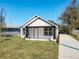 Beautifully renovated one-story house with stylish black and white exterior, a new driveway and landscaping at 1112 W Line St, Leesburg, FL 34748