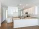 Bright open kitchen featuring white cabinets, stainless steel appliances, marble countertops, and an island with a sink at 1112 W Line St, Leesburg, FL 34748