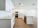 Bright open kitchen featuring white cabinets, stainless steel appliances, marble countertops, and an island with a sink at 1112 W Line St, Leesburg, FL 34748