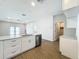 Bright kitchen features white cabinets, marble countertops, stainless steel appliances, and a central island with a sink at 1112 W Line St, Leesburg, FL 34748