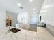 Bright open kitchen featuring white cabinets, stainless steel appliances, marble countertops, and an island with a sink at 1112 W Line St, Leesburg, FL 34748
