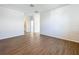 Spacious living room with hardwood floors and access to hallway bathroom at 1112 W Line St, Leesburg, FL 34748