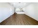 Spacious living room boasts wood-look flooring and a view into the bright, modern kitchen at 1112 W Line St, Leesburg, FL 34748