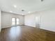 Spacious living room with luxury vinyl plank flooring, recessed lighting, and a glass door to a rear patio at 1112 W Line St, Leesburg, FL 34748