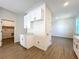 This is an inside view of the pantry in the kitchen with white cabinets and grey walls and light brown, vinyl floors at 1112 W Line St, Leesburg, FL 34748