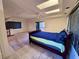 Bedroom featuring a comfortable bed, skylights, and a ceiling fan for a well-lit and airy ambiance at 11290 Se 189Th Ct, Ocklawaha, FL 32179