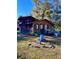 Rustic two-story home featuring a wood exterior, a small porch, and mature trees in a partially sunny yard at 11290 Se 189Th Ct, Ocklawaha, FL 32179