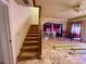 Carpeted staircase leading to an open living area, enhancing the home's architectural appeal and functionality at 11290 Se 189Th Ct, Ocklawaha, FL 32179