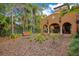 Expansive backyard with lush tropical landscaping, bench, and outdoor dining area at 1141 S Osceola Ave, Orlando, FL 32806