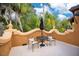 Charming balcony featuring an umbrella table set and decorative wall overlooking lush greenery at 1141 S Osceola Ave, Orlando, FL 32806