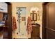 Stylish bathroom featuring a glass shower, dark wood vanity, arched alcove, and elegant decor at 1141 S Osceola Ave, Orlando, FL 32806