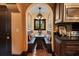 Cozy breakfast nook with built-in bench seating, terracotta tile floor, and arched doorway to kitchen at 1141 S Osceola Ave, Orlando, FL 32806
