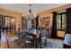 Spacious dining room featuring hardwood floors, decorative chandelier and large windows with black frames at 1141 S Osceola Ave, Orlando, FL 32806