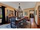 Elegant dining room featuring hardwood floors, chandelier, and a dark wood table with ornate detailing at 1141 S Osceola Ave, Orlando, FL 32806