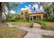 Charming Spanish-style home with lush landscaping, mature trees, and a tile roof at 1141 S Osceola Ave, Orlando, FL 32806