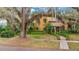 Inviting Spanish-style home with mature trees and landscaping, showcasing its unique architectural charm at 1141 S Osceola Ave, Orlando, FL 32806